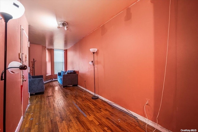 interior space with dark wood-type flooring and a baseboard radiator