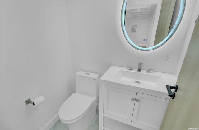 bathroom with tile patterned flooring, vanity, and toilet