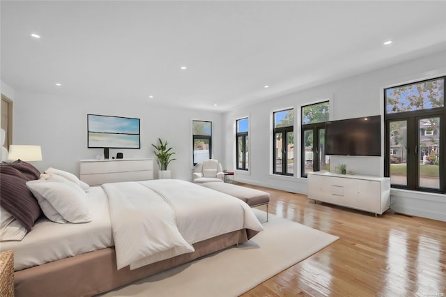 bedroom featuring light wood-type flooring and multiple windows