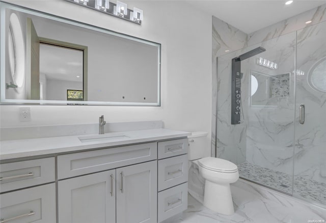 bathroom featuring vanity, toilet, and a shower with shower door