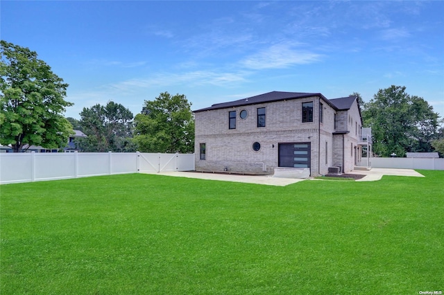 back of house with central air condition unit, a patio area, and a lawn