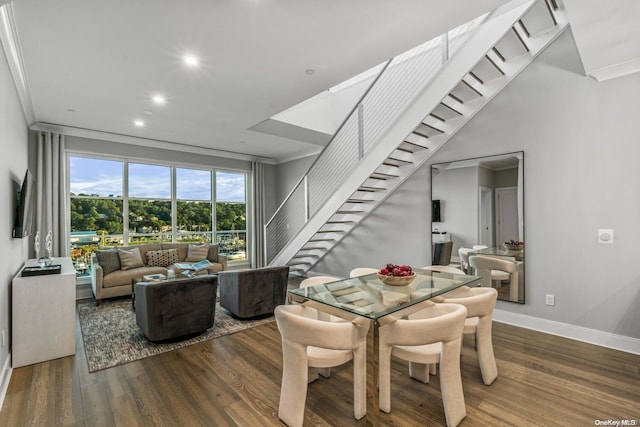 dining room with crown molding and dark wood-type flooring