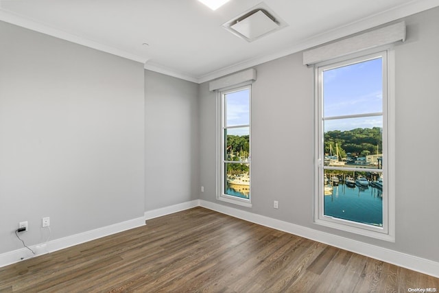 unfurnished room with crown molding, dark hardwood / wood-style flooring, and plenty of natural light