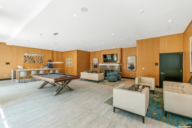 recreation room with pool table and wood walls