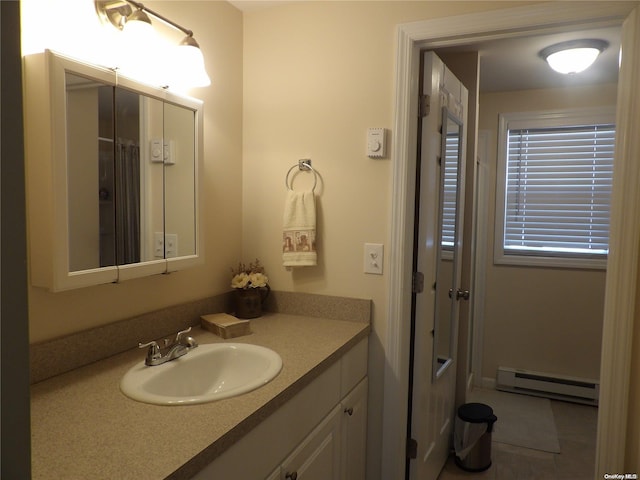 bathroom with tile patterned floors, vanity, and a baseboard radiator