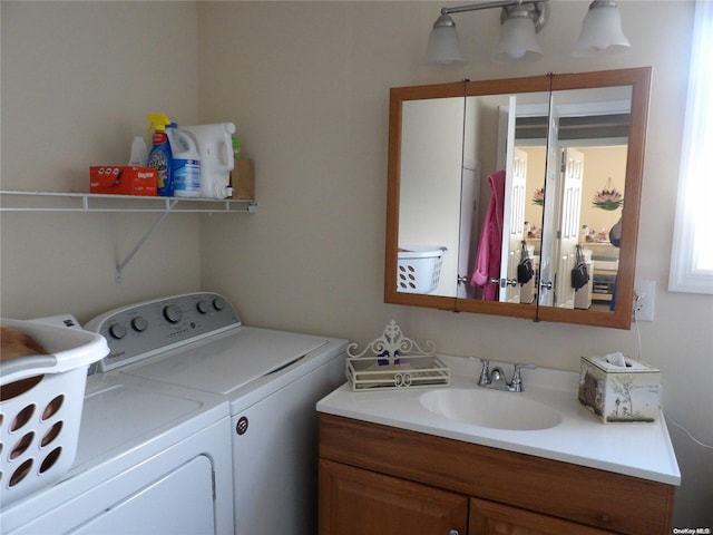 clothes washing area featuring washer and clothes dryer and sink