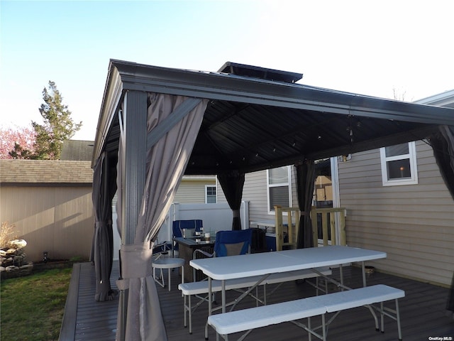 wooden terrace featuring a gazebo