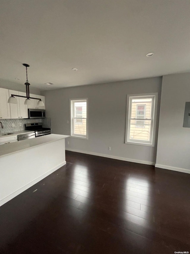 unfurnished living room featuring dark hardwood / wood-style floors and sink