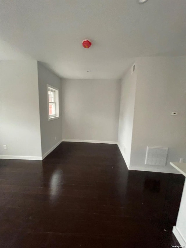 empty room with dark hardwood / wood-style floors