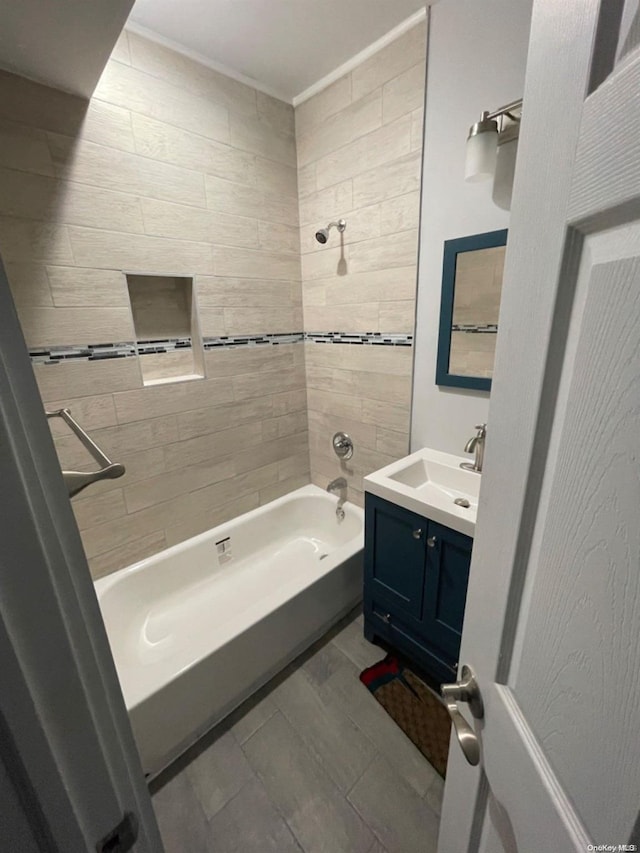 bathroom featuring vanity and tiled shower / bath