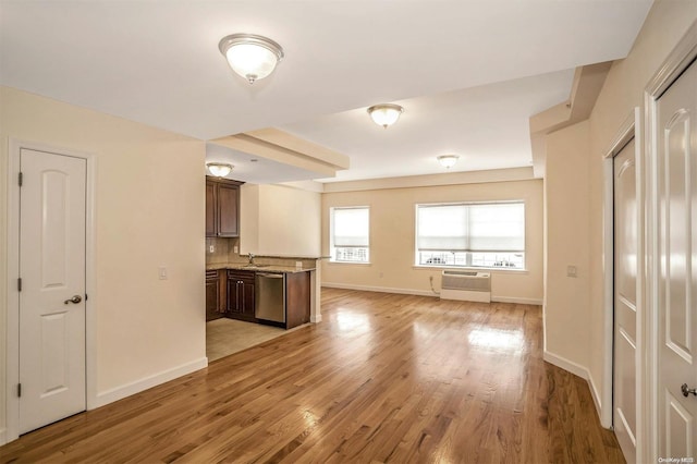 interior space featuring a wall mounted AC, light hardwood / wood-style flooring, and sink