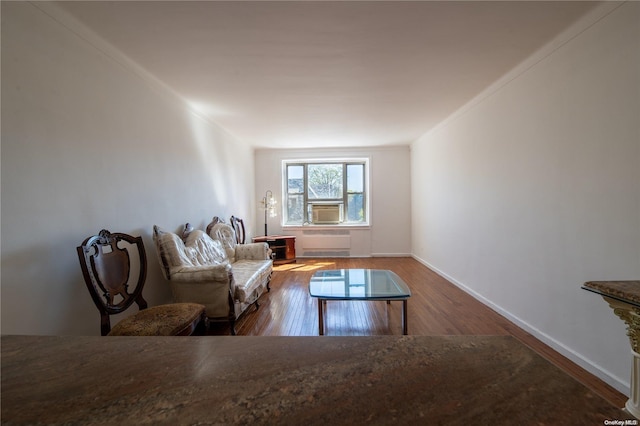 living room featuring hardwood / wood-style flooring, cooling unit, and ornamental molding