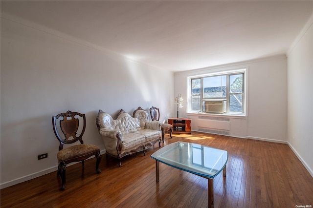 sitting room with hardwood / wood-style flooring, ornamental molding, and radiator