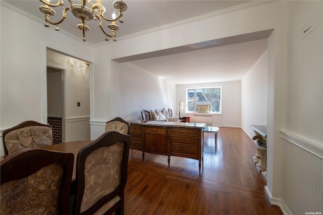 bedroom with dark hardwood / wood-style flooring, ornamental molding, and an inviting chandelier