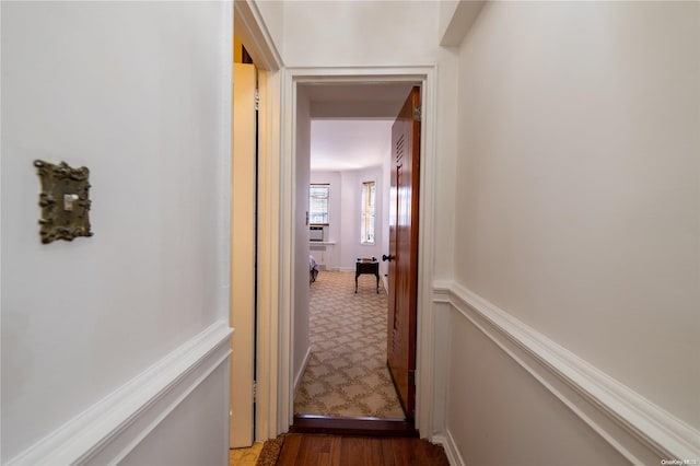 corridor with wood-type flooring