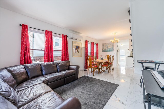 living room featuring a wall mounted AC and a chandelier