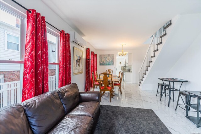 living room featuring a notable chandelier and a wall unit AC