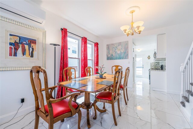 dining space featuring a wall mounted AC and a notable chandelier