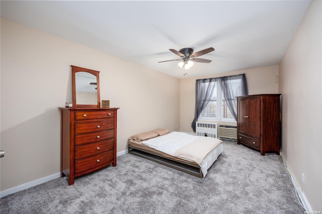 carpeted bedroom featuring ceiling fan and radiator heating unit