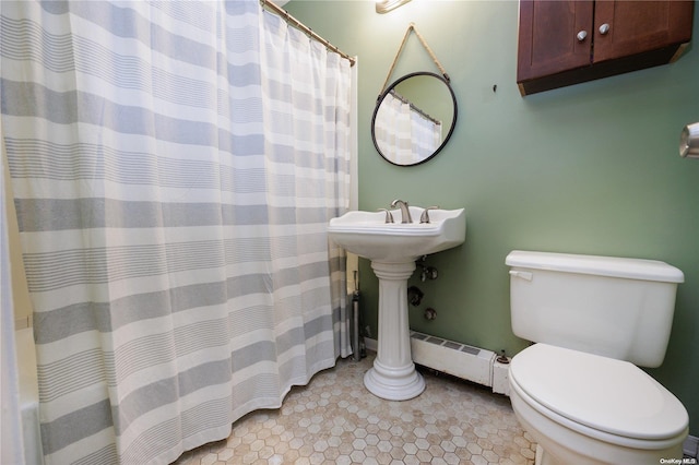 bathroom featuring baseboard heating, sink, and toilet