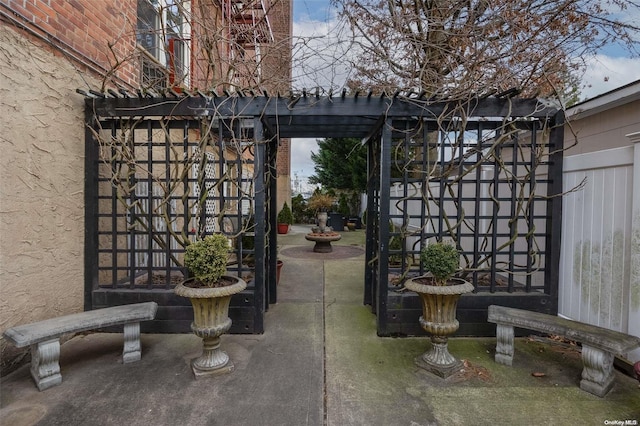 view of gate with a patio