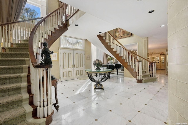 foyer featuring a towering ceiling