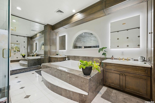 bathroom with plus walk in shower, vanity, and tile patterned flooring