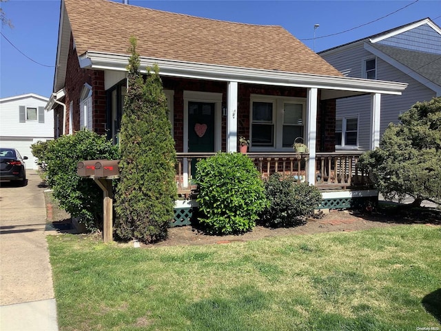 bungalow-style house with a front lawn