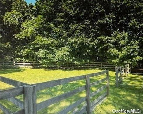 view of gate with a yard