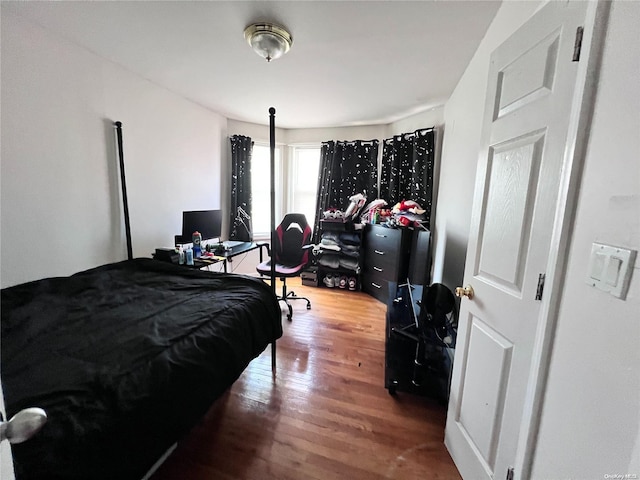 bedroom with hardwood / wood-style floors