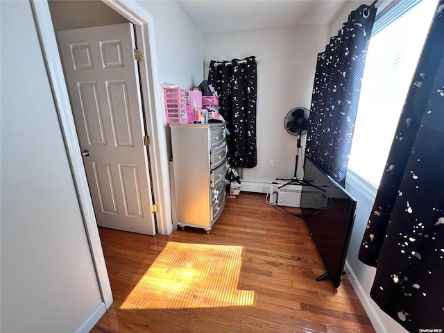 corridor with hardwood / wood-style floors