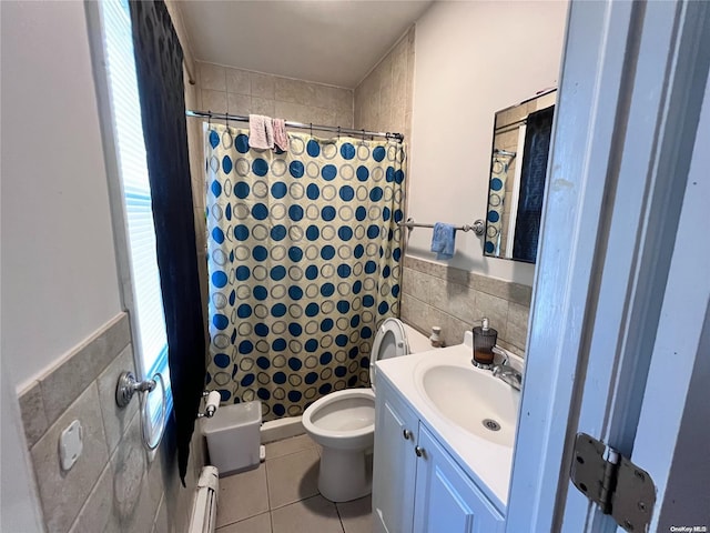 bathroom featuring tile patterned floors, vanity, tile walls, and a baseboard heating unit