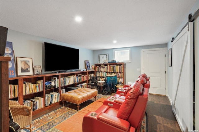 living room with dark hardwood / wood-style flooring and a barn door