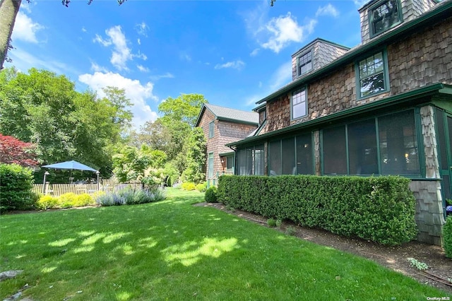 view of yard with a sunroom