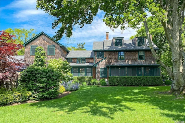 back of house featuring a sunroom and a yard