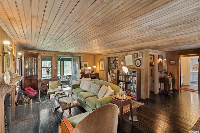 living room with dark wood-type flooring, wooden ceiling, and wooden walls