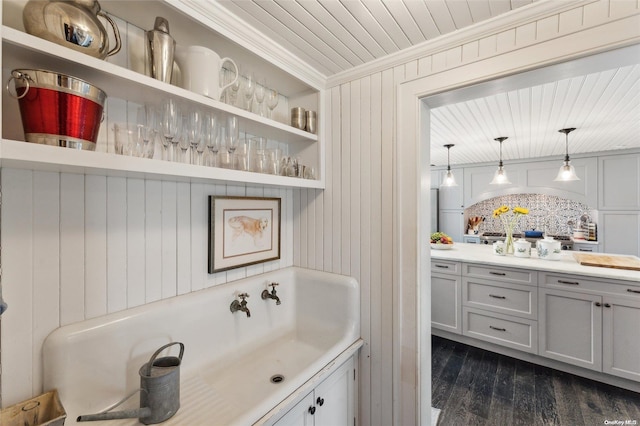 bathroom featuring backsplash, crown molding, hardwood / wood-style floors, wood walls, and vanity