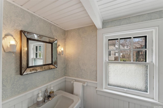 bathroom featuring beamed ceiling, wooden ceiling, and sink