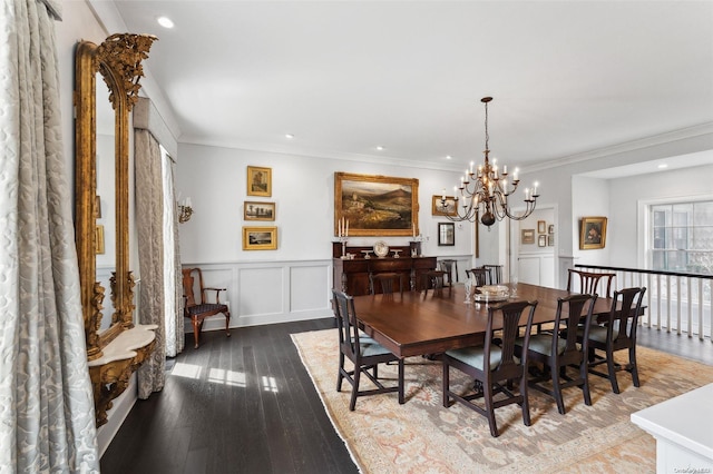 dining space with crown molding, hardwood / wood-style floors, and a notable chandelier