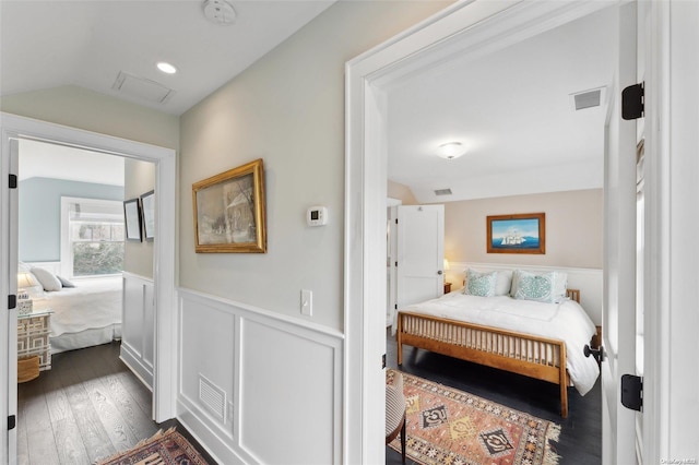 bedroom with dark hardwood / wood-style floors and vaulted ceiling