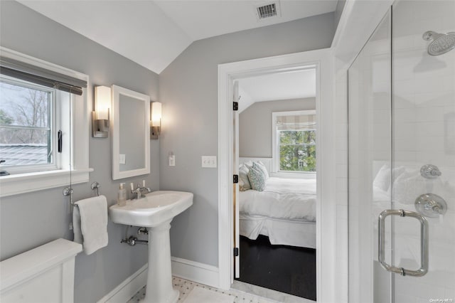 bathroom featuring lofted ceiling and walk in shower