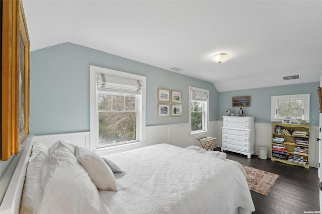 bedroom with vaulted ceiling and dark wood-type flooring