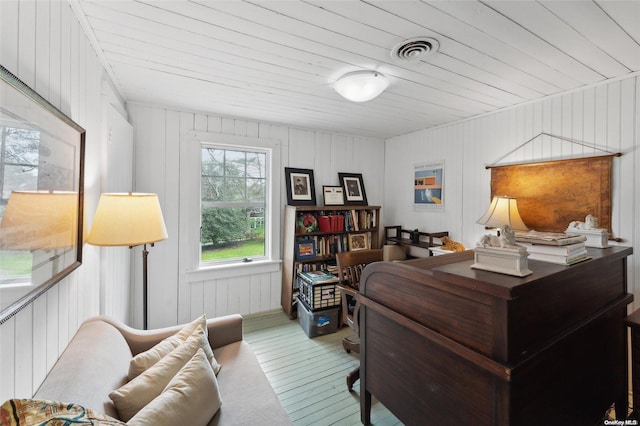 office with hardwood / wood-style floors, wood ceiling, and wooden walls