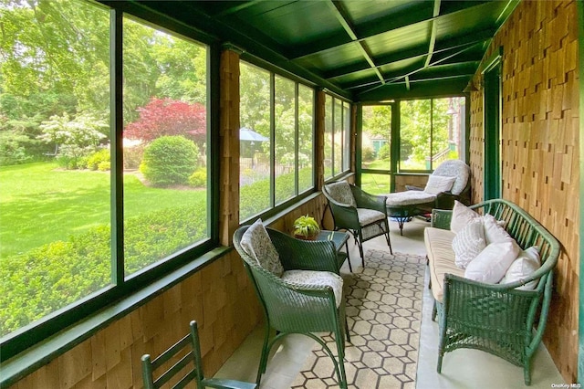 sunroom with a healthy amount of sunlight and lofted ceiling