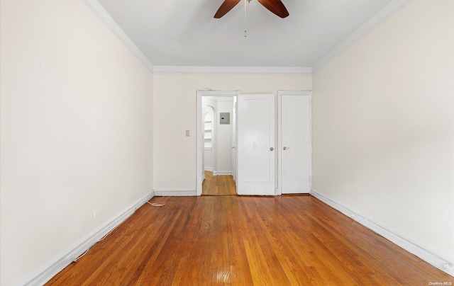 unfurnished bedroom featuring ceiling fan, crown molding, and hardwood / wood-style flooring