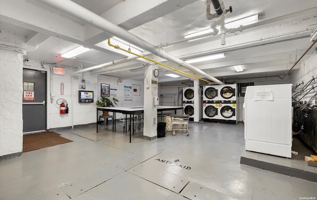 garage with stacked washing maching and dryer