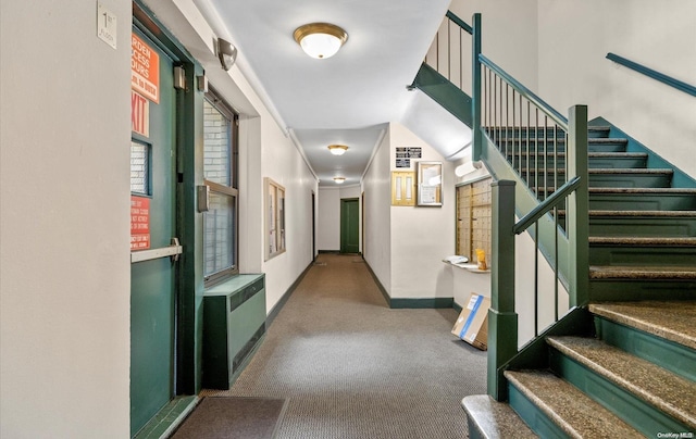 corridor featuring light colored carpet