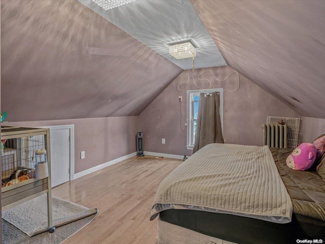 bedroom with hardwood / wood-style flooring and vaulted ceiling