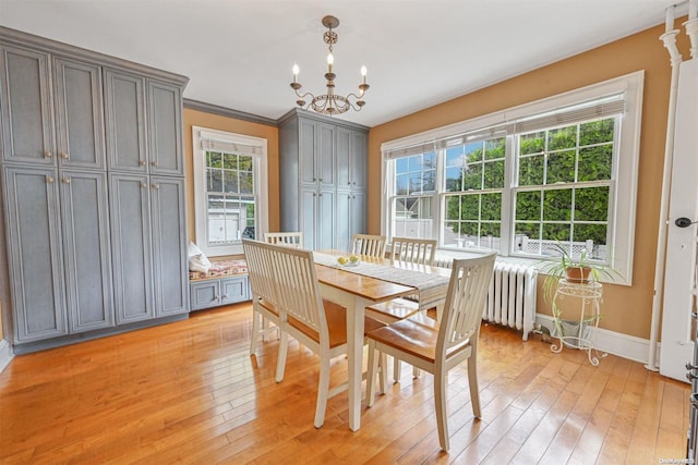 dining room featuring ornamental molding, light hardwood / wood-style floors, and a healthy amount of sunlight