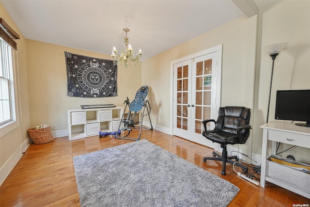 living area with a chandelier, french doors, and wood-type flooring